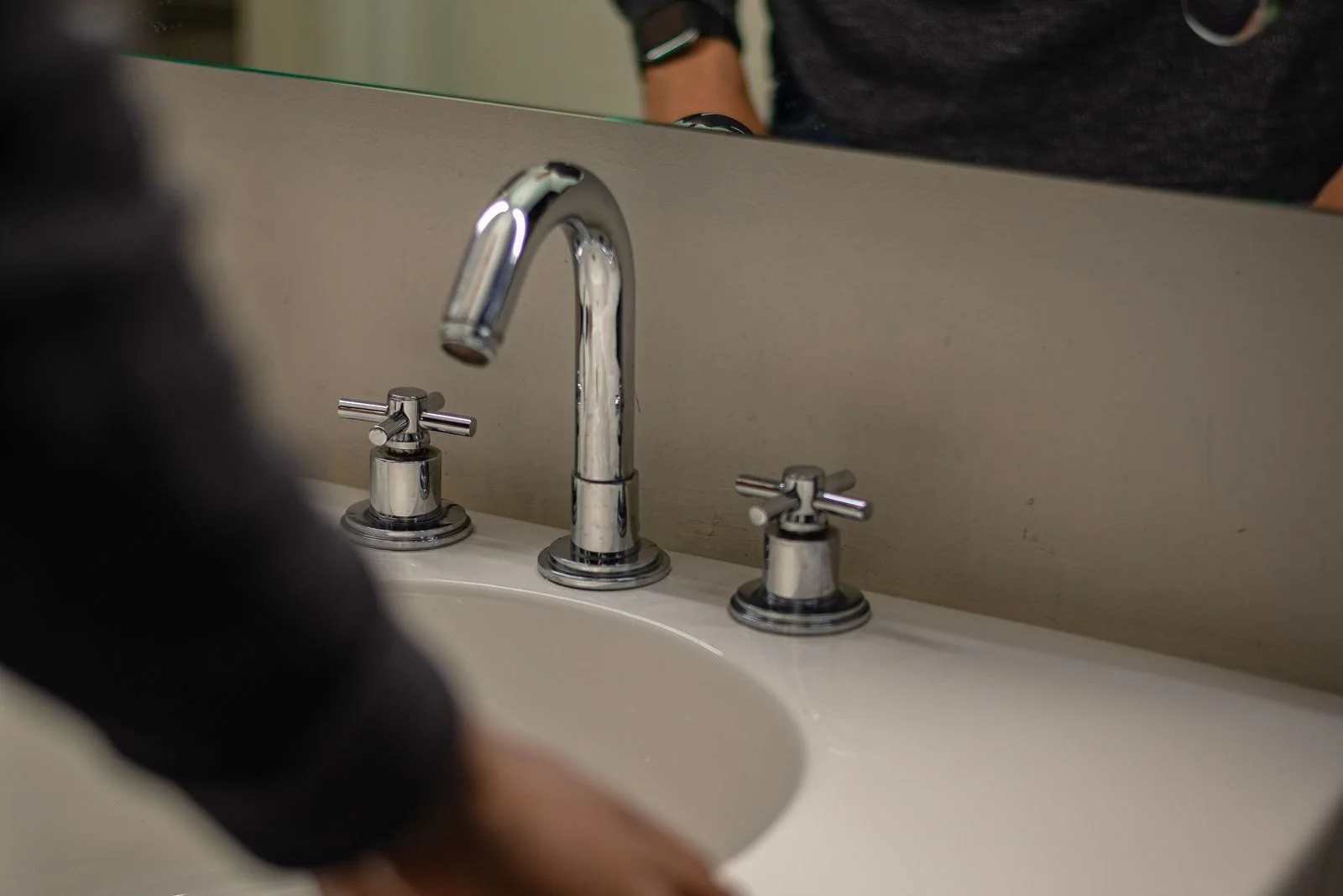 a widespread lavatory faucet and basin being checked over by a bathroom plumber cleveland tn homeowners call for fixture repairs