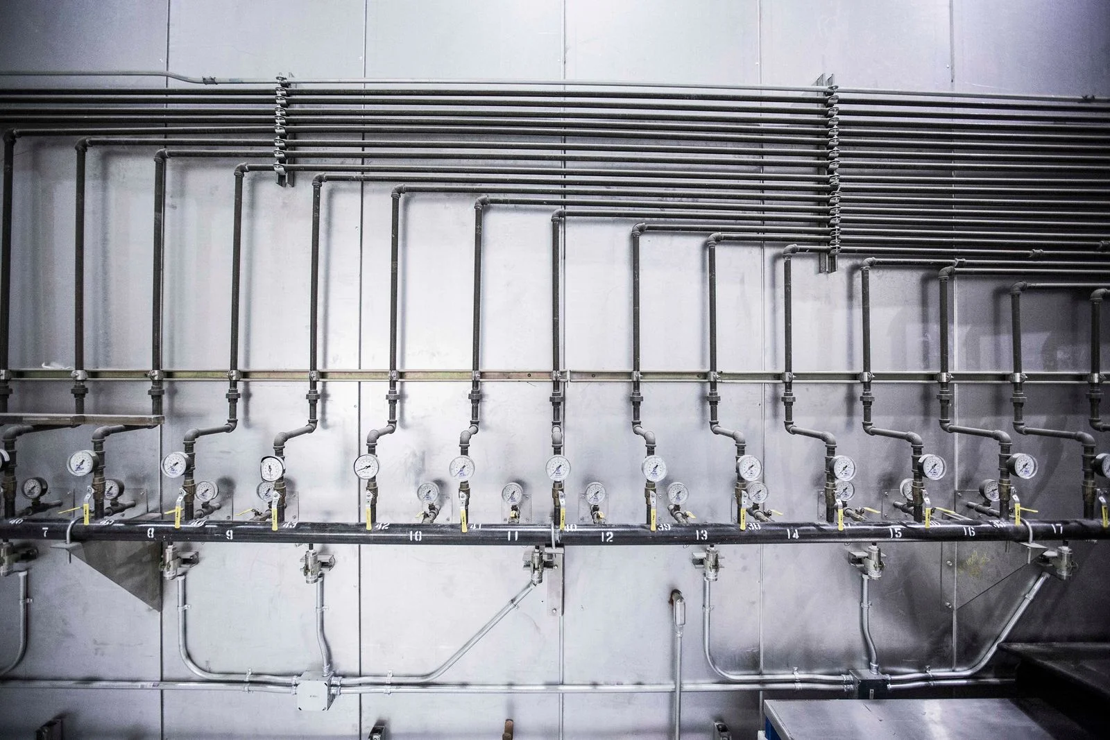 a run of pressurised pipework with a shut-off valve and a gauge on every branch, the arrangement commercial water leak detection works through