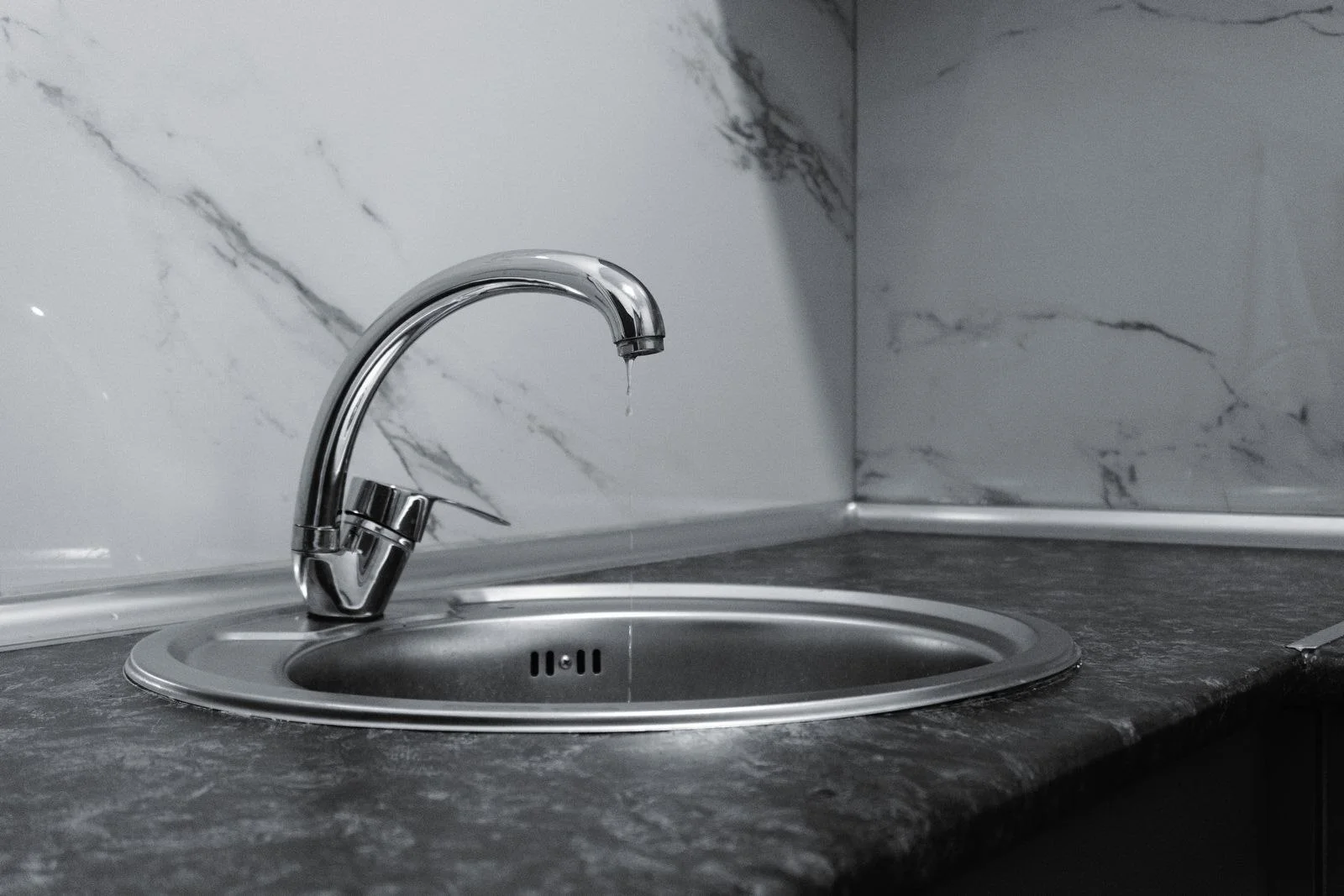 a single-lever mixer left dripping over a sink, the commonest call for faucet repair and bathroom plumbing service