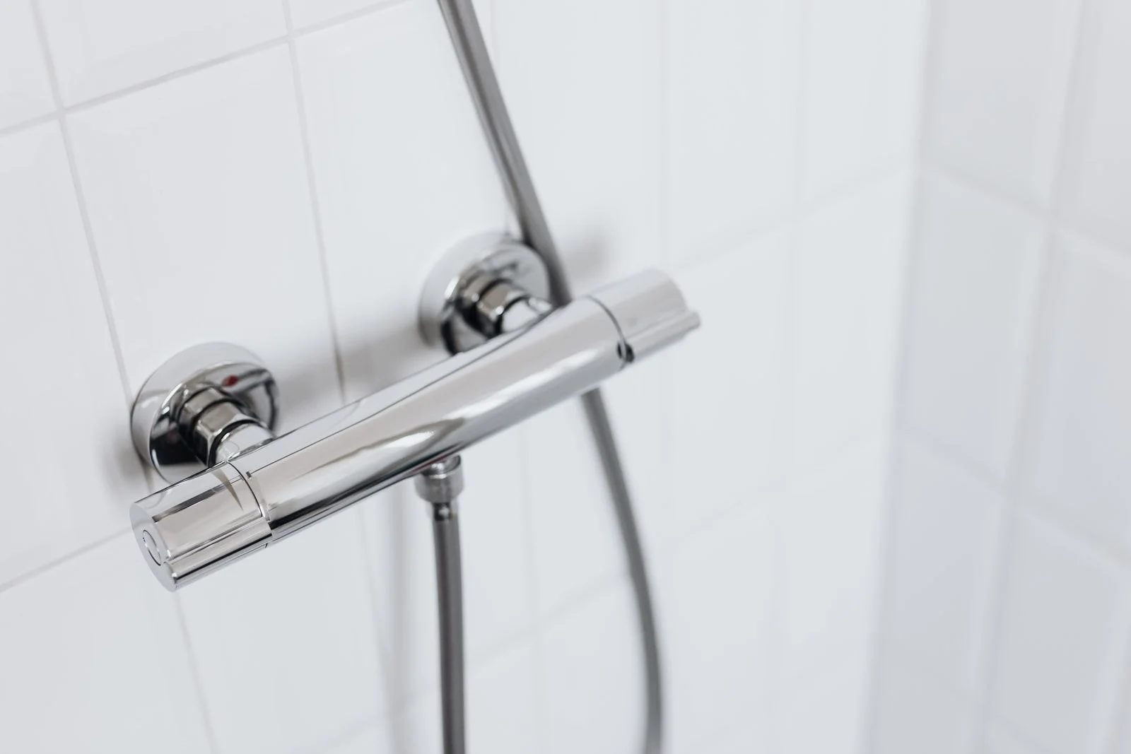 a chrome balanced shower valve on tiled wall, the part replaced in most shower faucet repair work in Cleveland TN