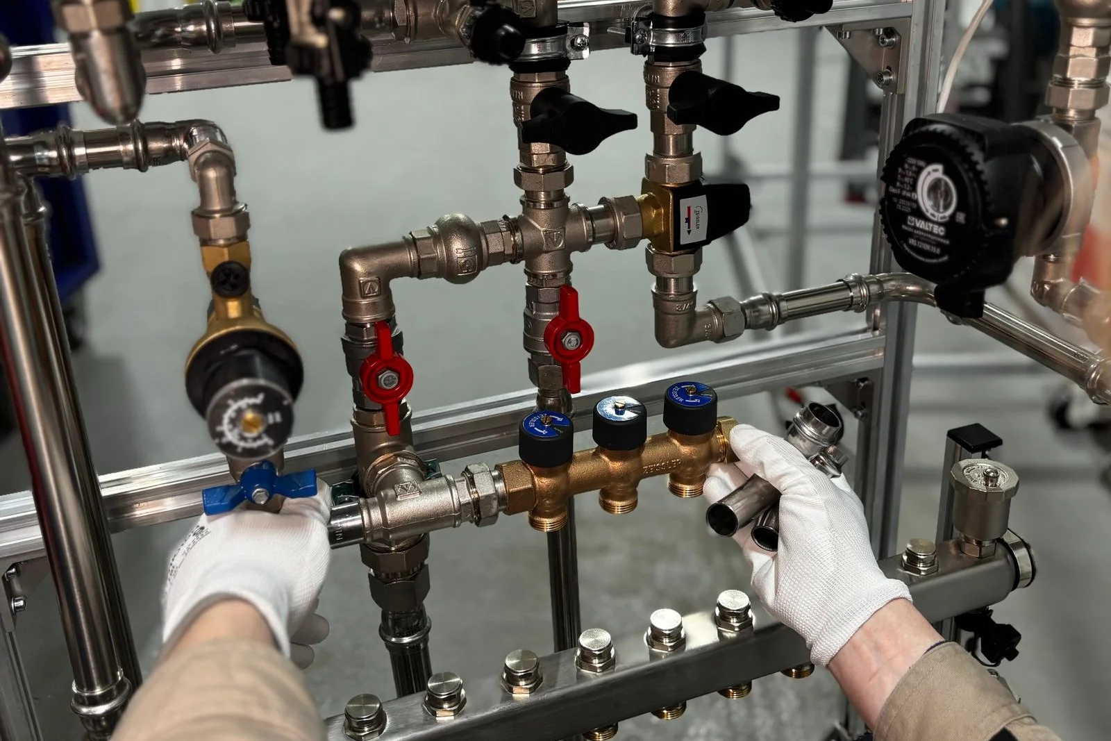 water pressure regulator gauge and supply manifold checked by a plumber in ooltewah tn